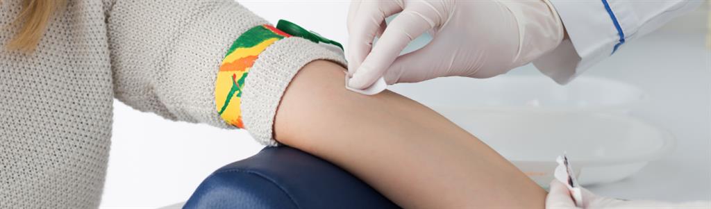 woman's arm is being prepared for a blood test.